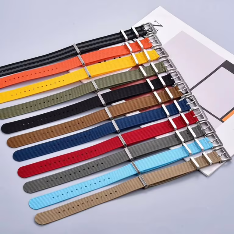 A variety of Ribbed Nylon NATO Straps in multiple colors, showcasing durable fabric and stainless steel buckles, arranged side by side for a vibrant, stylish display.