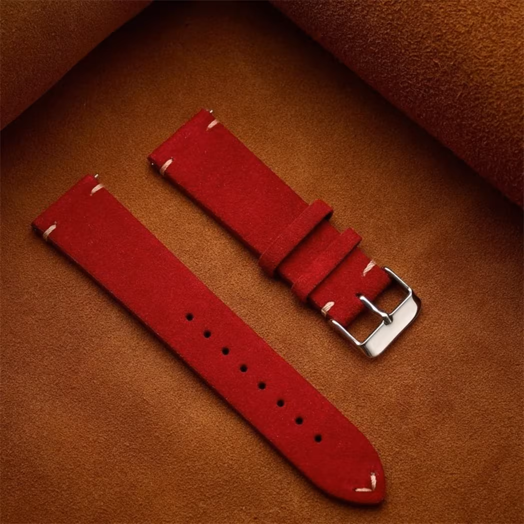 Vintage Calfskin Suede Watch Strap - (14, 16, 18, 19, 20, 21, 22mm) 19 Bold deep red genuine suede watch strap laid flat against a warm brown leather background.