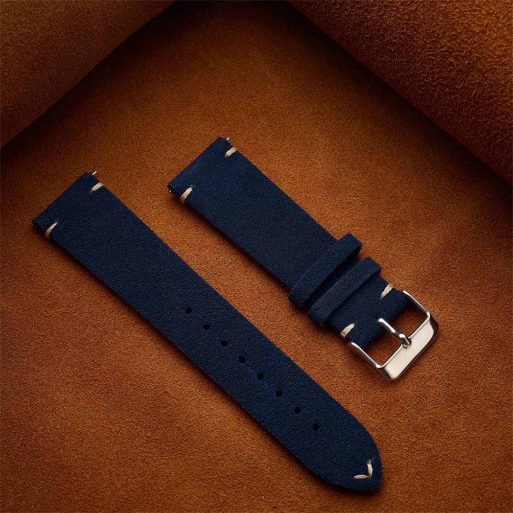 Vintage Calfskin Suede Watch Strap - (14, 16, 18, 19, 20, 21, 22mm) 16 Dark navy blue genuine suede replacement watch band laid flat against a brown background, featuring minimalist off-white accent stitching.