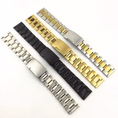 All four color options of the oyster-style watch strap in silver, black, gold, and two-tone, laid flat and parallel in a lineup.